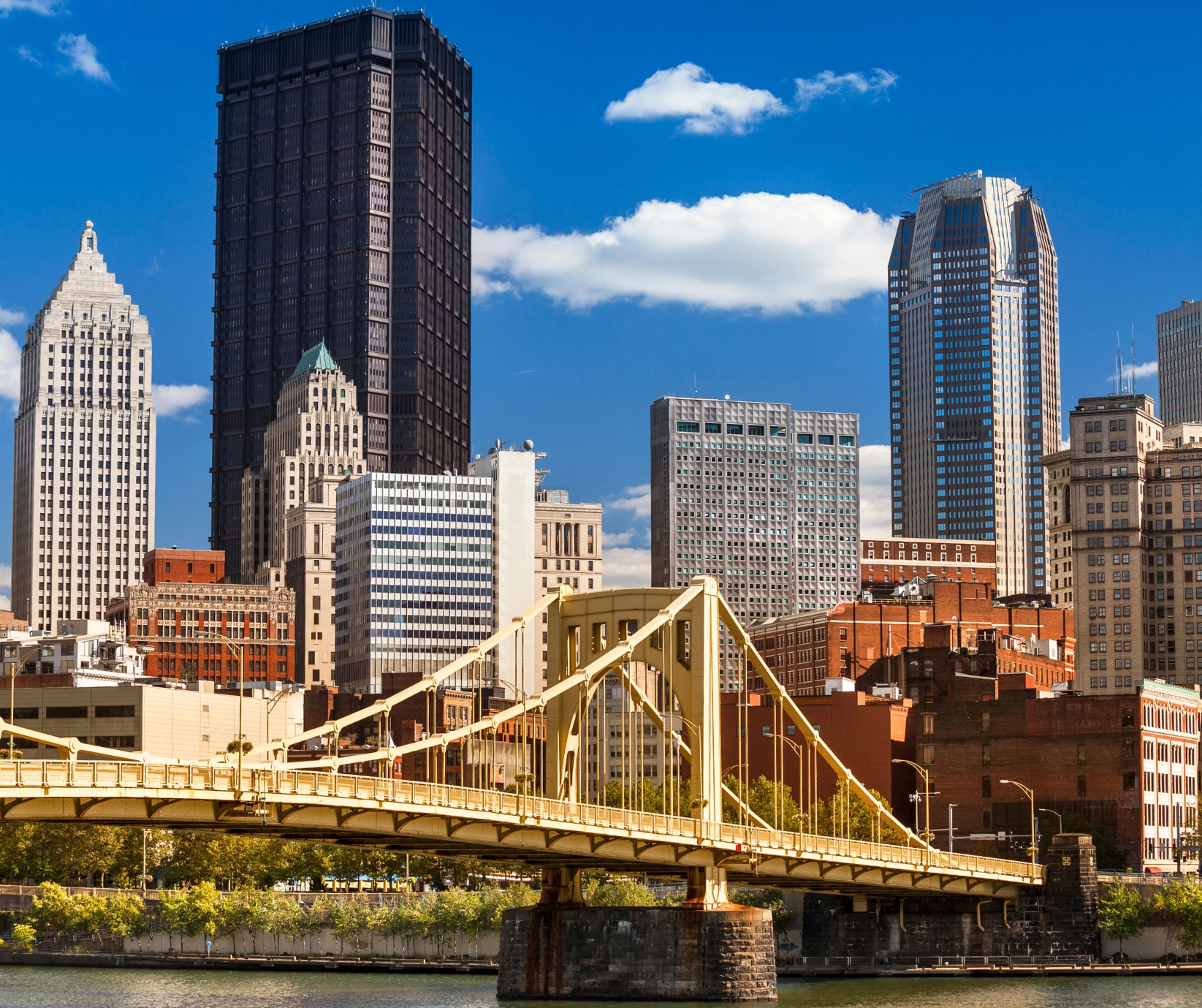 Pittsburgh bridge on a sunny day with skyline